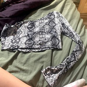 cropped off the shoulder on one side and long sleeve on the other side.